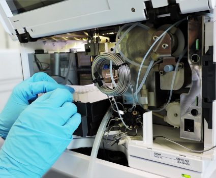 hplc-inside Scientist operating the high performance liquid chromatography for analytical chemistry and purification