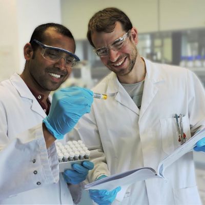 Research chemists collaborating in organic chemistry laboratory