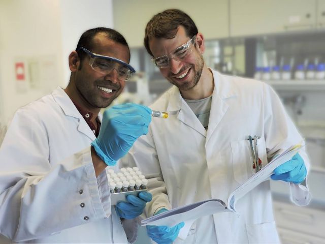 Research chemists collaborating in organic chemistry laboratory