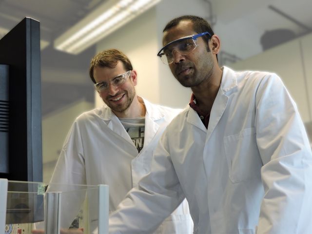Research Chemists Evaluation Research chemists evaluating results in organic chemistry laboratory